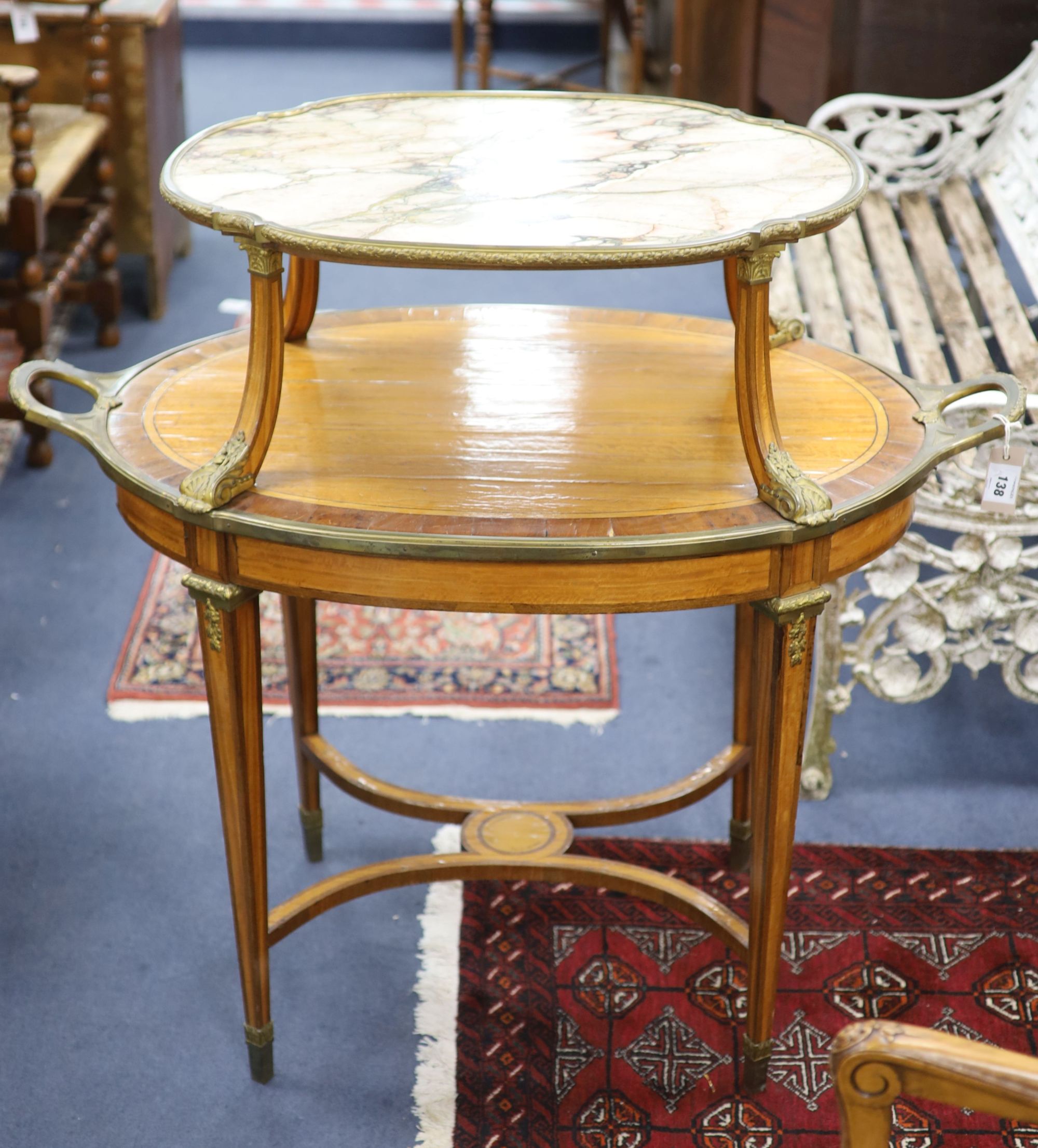 A late 19th century French satinwood, rosewood crossbanded and gilt metal mounted two tier oval etagere